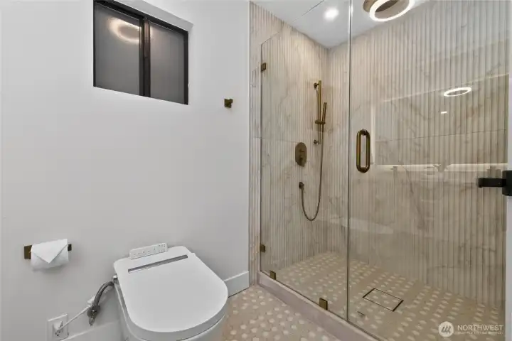 Gorgeous walk-in shower is double-headed with a rain shower head.
