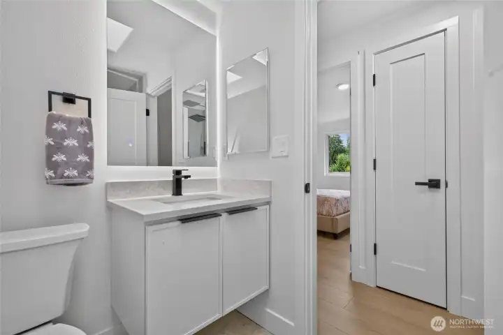 Hall bathroom with backlit LED mirror, medicine cabinet & linen closet.