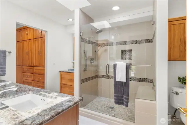 Primary bathroom & walk-in closet fully updated with beautiful pecan cabinetry, tile & quartz.