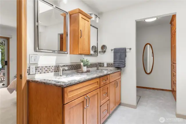 Primary bathroom & walk-in closet fully updated with beautiful pecan cabinetry, tile & quartz.