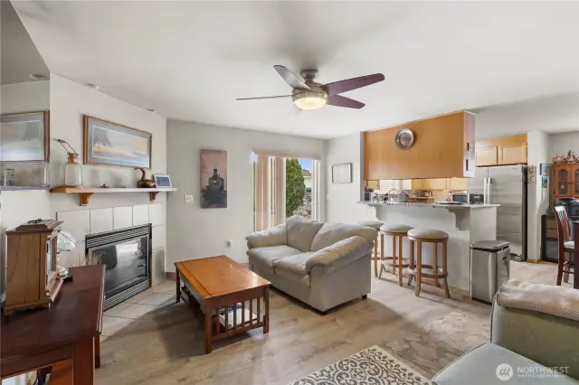Living room with fireplace and ceiling fan.
