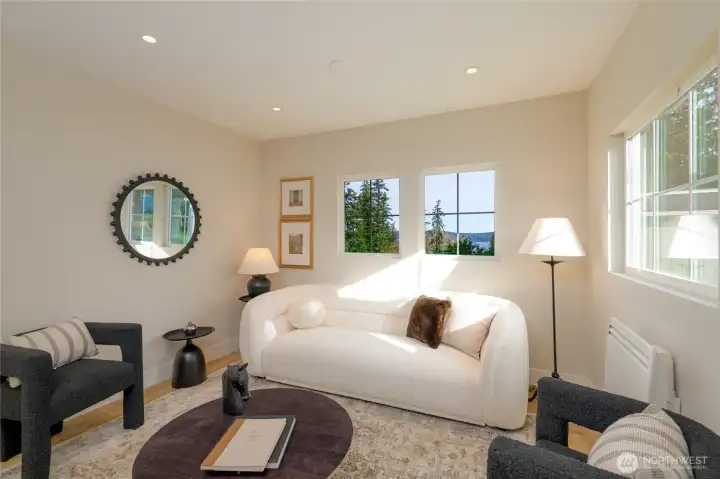 main level entry family seating room with water views