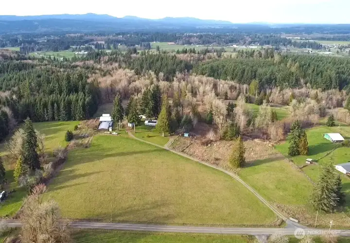 Lundeen rd in the foreground showing driveway into property.