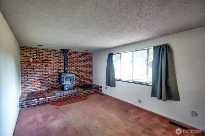 living room w/woodstove. Remove wall on left to create great room concept