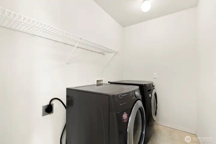 Large laundry room with room for storage.