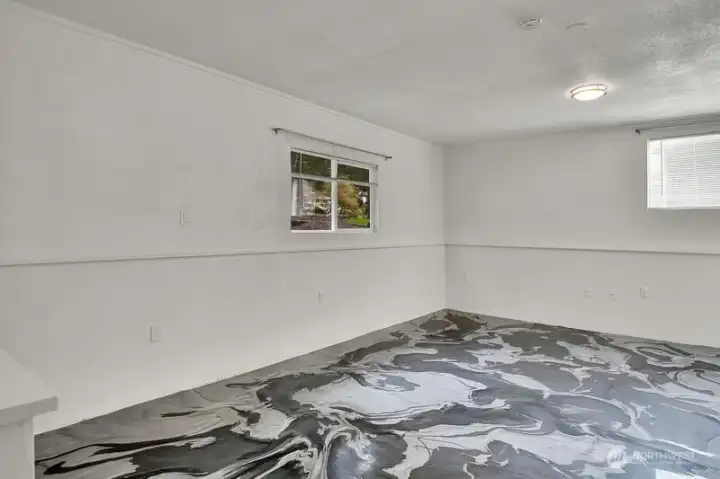 Primary bedroom with artistic floor surface