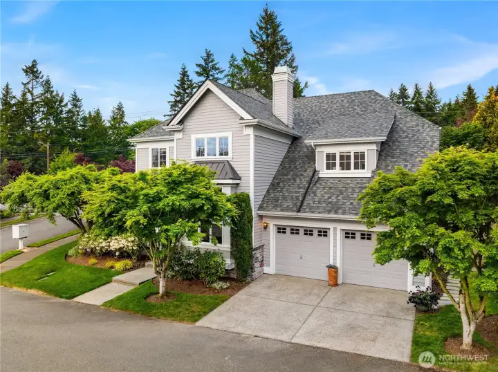 Striking curb appeal with sophisticated gray and white exterior accented by a vibrant red front door and two car garage.