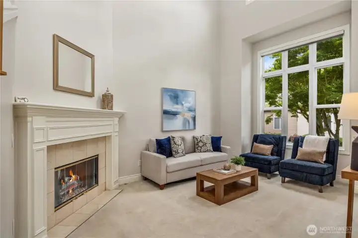Elegant formal living room to the right of the entry features a cozy gas fireplace.