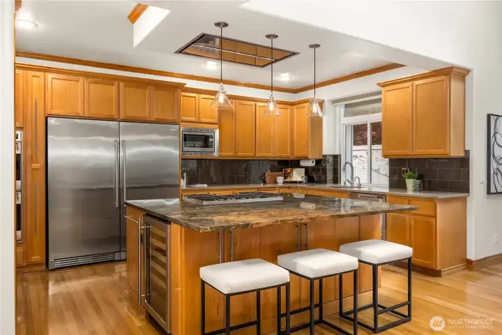 Kitchen features a double oven, warming drawer, drawer dishwashers, wine fridge, & extra-large refrigerator & freezer —perfectly equipped for both everyday living & entertaining.
