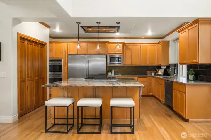 Abundant warm cabinetry and generous counter space provide both beauty and function.