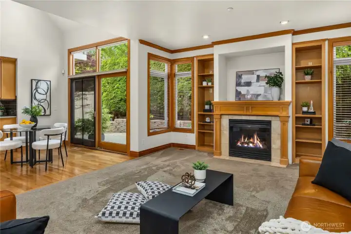 Inviting living room complete with gas fireplace, built-ins, and thoughtfully positioned windows.