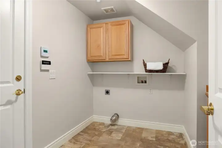 Downstairs laundry room with plenty of storage.