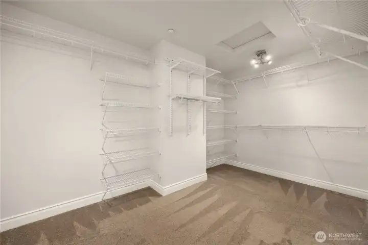 Spacious primary walk-in closet provides ample storage for all your wardrobe needs.
