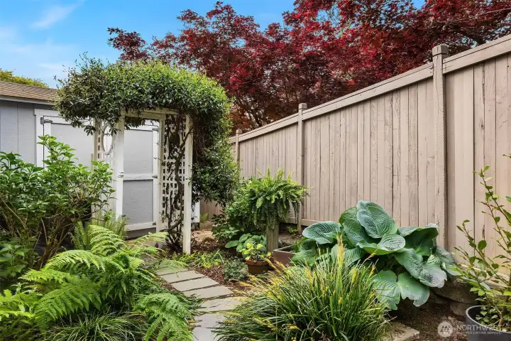 Backyard also features a charming pond surrounded by mature landscaping.