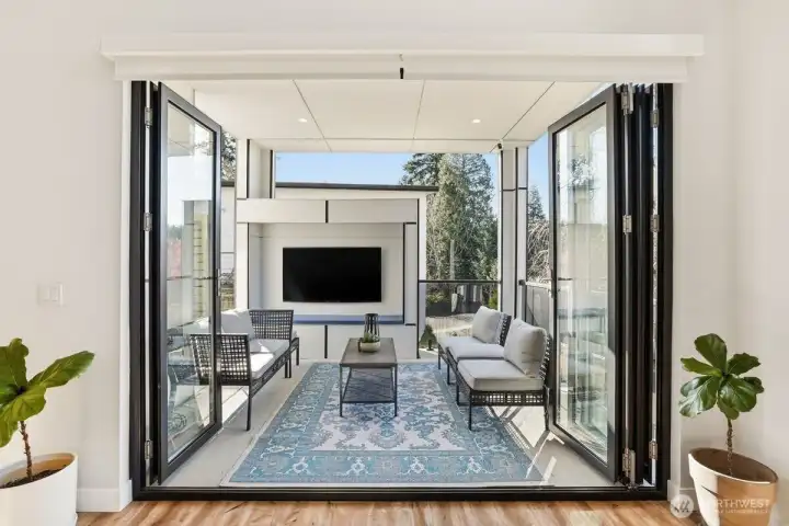 Main level covered outdoor deck with nano doors.