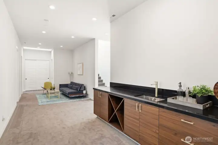 Head upstairs to open loft area with built in beverage station.