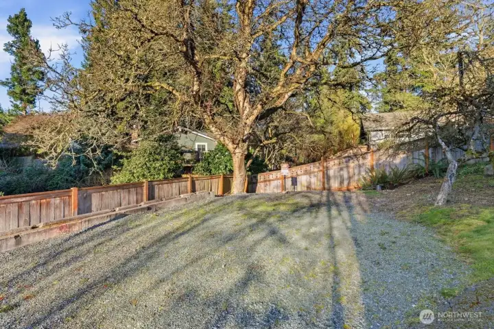 Nice outdoor area to make your own! Turf, add a swing set, or simply use as parking pad for extra  parking!