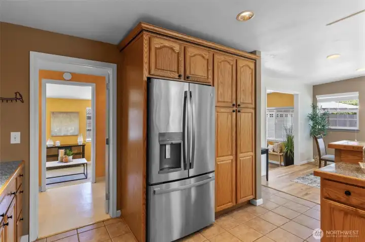 Kitchen leads through laundry to family room