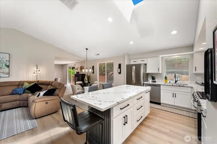 The open floor plan seamlessly connects the living, dining, and kitchen spaces. The open floor plan seamlessly connects the living, dining, and kitchen spaces.