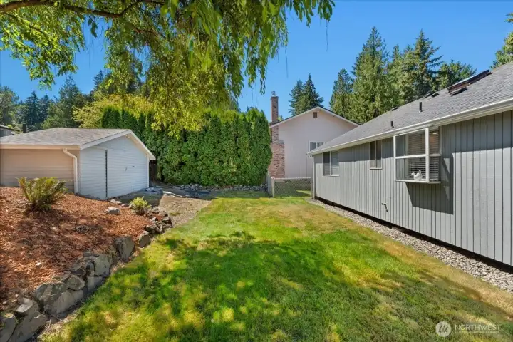 Private backyard offers a peaceful setting surrounded by mature landscaping and a shed for extra storage or lawn equipment. Private backyard offers a peaceful setting surrounded by mature landscaping and a shed for extra storage or lawn equipment.