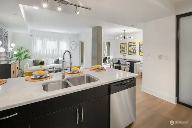 Looking from the kitchen toward the living and dining areas.  You can see how flexible and large this space is to handle all size groups.  And how the outside light flows in.