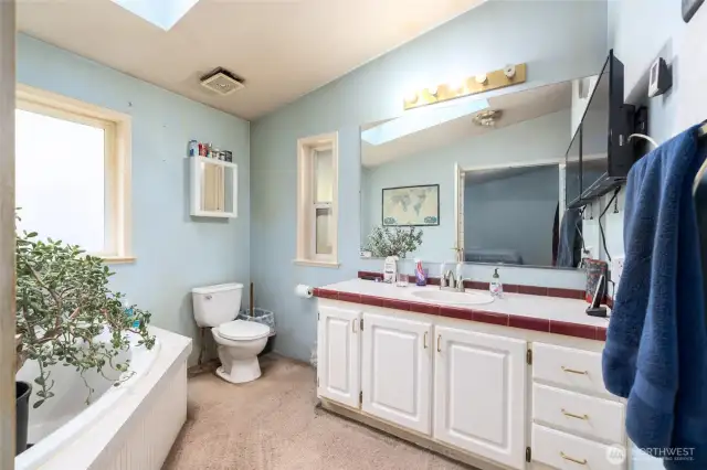 Primary bathroom has a large soaking tub plus a shower.