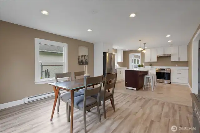 View of the dining area and open kitchen from the front window.