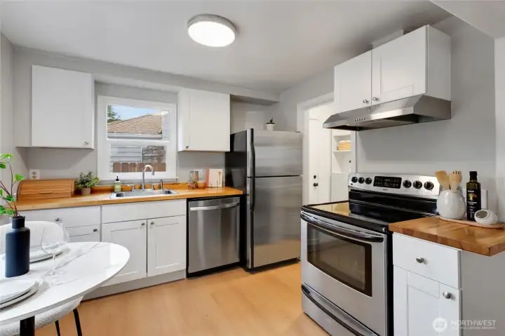 Kitchen features abundant natural light and modern appliances.