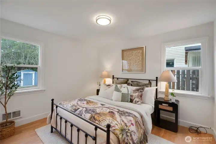 Bedroom with windows that open to the side and backyard