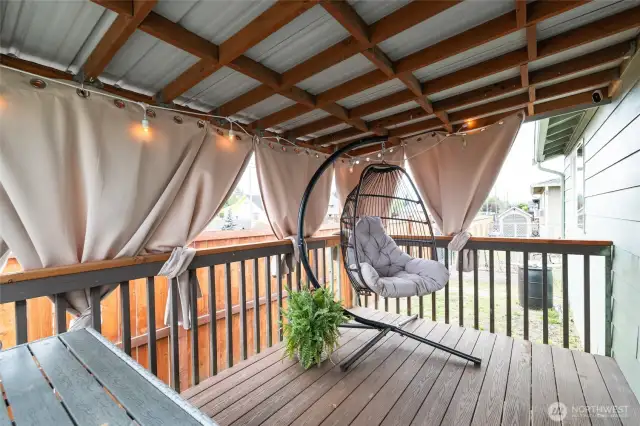 You'll love hanging out on this cute, covered deck with privacy curtains accessed through the dining room.