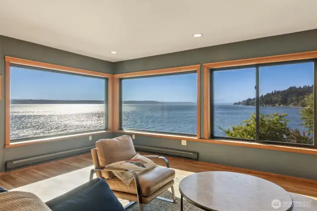 Main floor living room with panoramic, far-reaching views of Mount Rainier, Cascade Mountains, Puget Sound, Des Moines, fireworks displays, boats of all types and sea life!