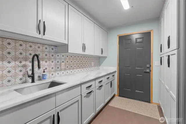 The massive pantry with a walk-in featuring custom shelving and a shower