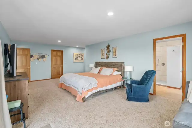 Owner Suite designed like a full hotel room with dual walk-in closets, ensuite luxury bathroom, sitting area, and your own private view deck.