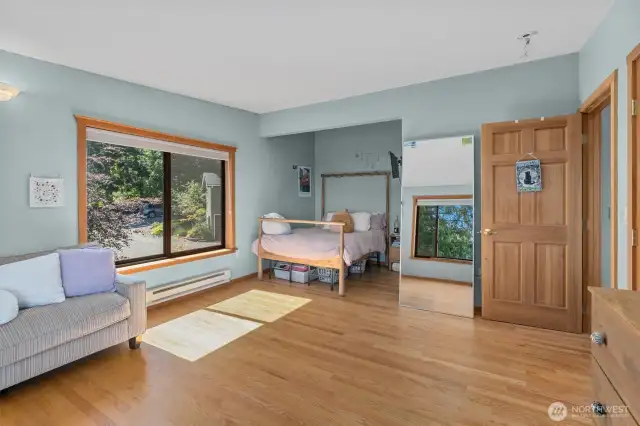 2nd Primary Suite on the upper floor with walk-in closet and views of Puget Sound and the woods. It features its own walk-in closet and fully remodeled bathroom.