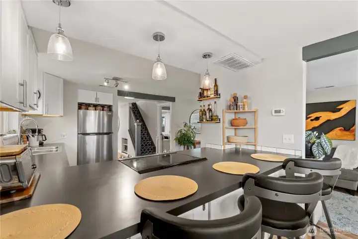 Room for four bar stools.  Beautiful quartz countertops and updated appliances