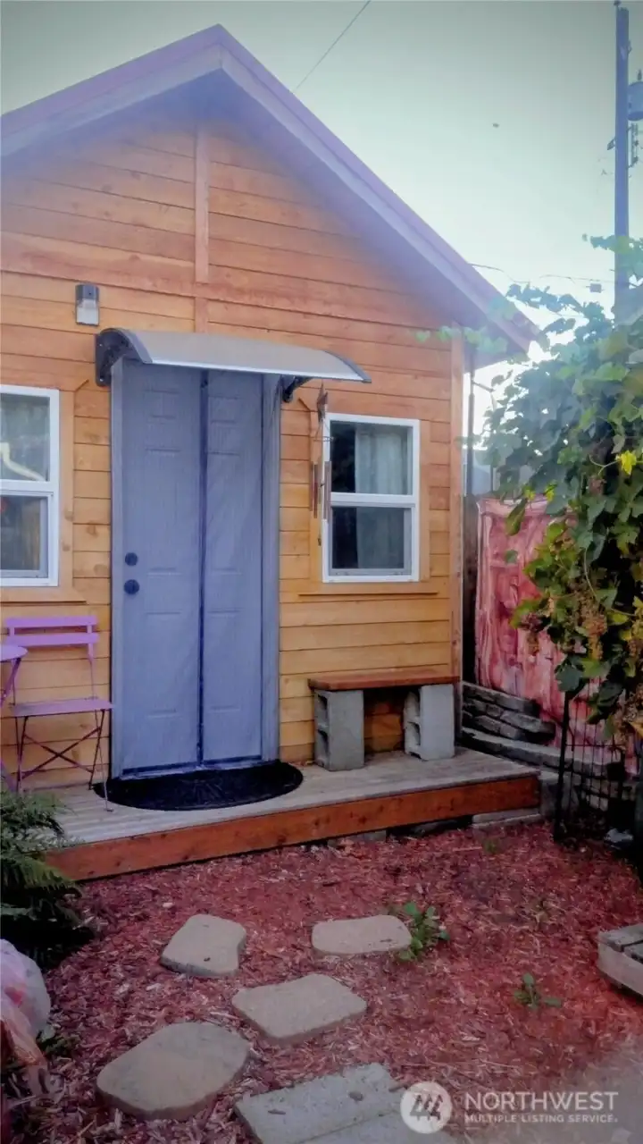 Detached studio currently used as the third bedroom as a family member does music jams in here. There is hardwired electricity but no drywall.  This is in the corner of the backyard near the storage shed and two car garage.  There is a yard set up for this studio and it is fenced.