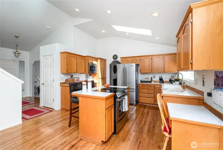 Kitchen also has a generously-sized island with a cooktop and seating, perfect for everyday living & entertaining.