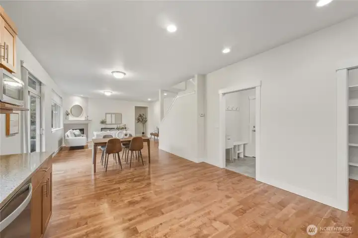 A view from the kitchen back towards the living room with a walk-in pantry and laundry room on the right.