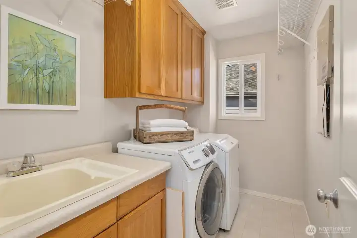 The laundry room is conveniently located on the upper floor.