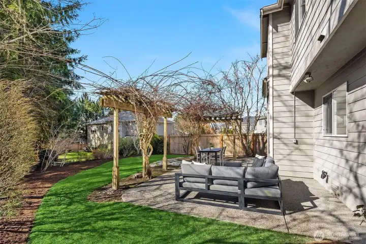 The professionally landscaped yard offers tons of privacy.