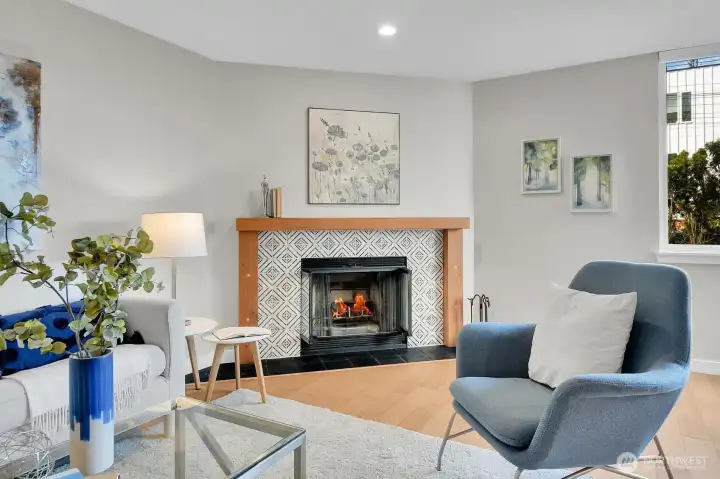 Glass doors and custom tile and woodwork make this wood-burning fireplace the star of the living room.
