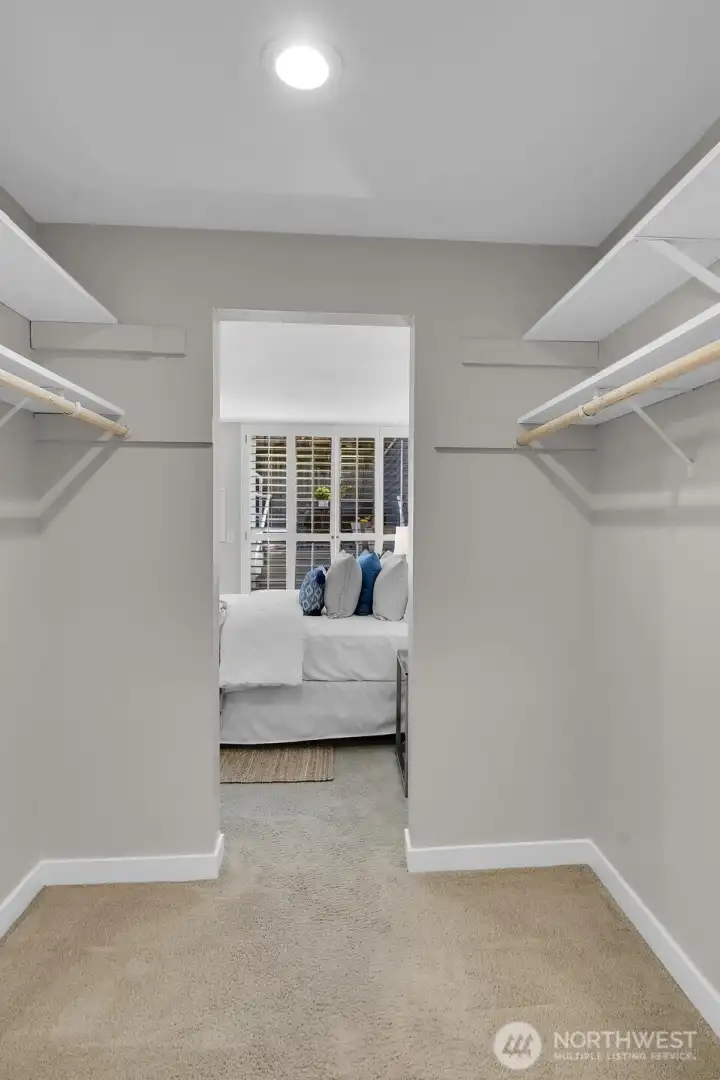 A huge walk-in closet connects the primary bedroom and bathroom.