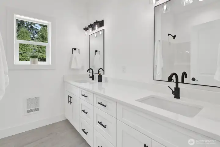 Primary bathroom with double sinks and modern finishes