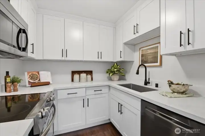 The kitchen has been upgraded with white shaker soft close cabinetry, new hardware and quartz countertops. The kitchen has been upgraded with white shaker soft close cabinetry, new hardware and quartz countertops.