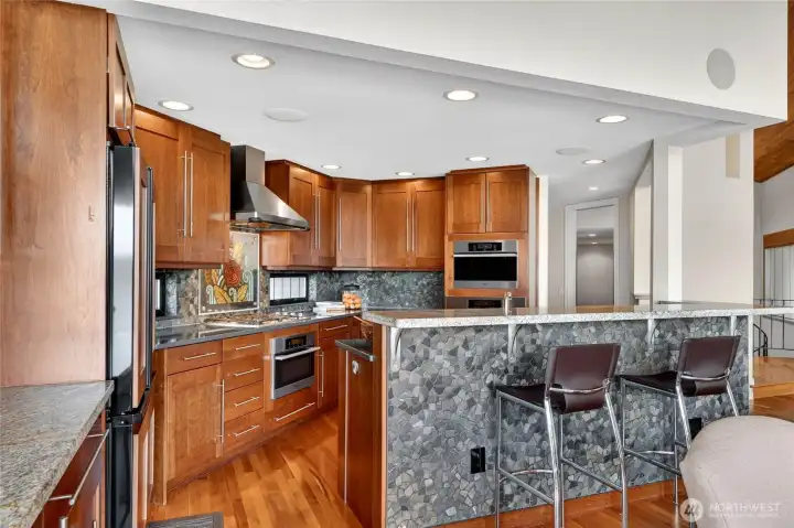 A kitchen for a chef AND an artist. A textural Northwest stone backsplash.