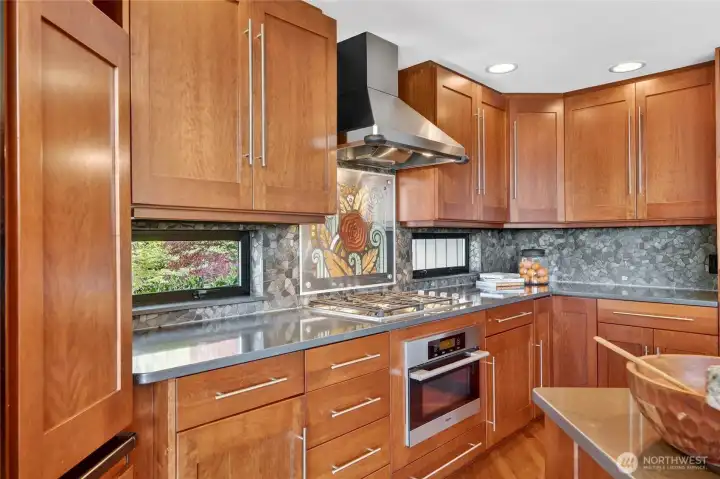 Gas cooktop and a  Microwave within reach.