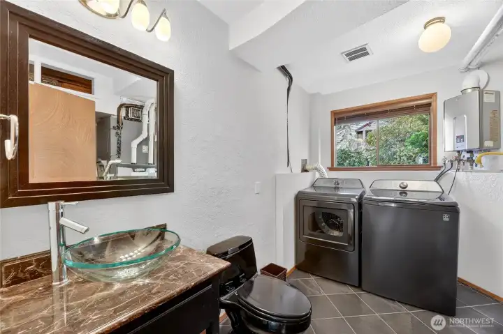 Lower level laundry and half bath.  (room to put in a shower for future plans you may have)