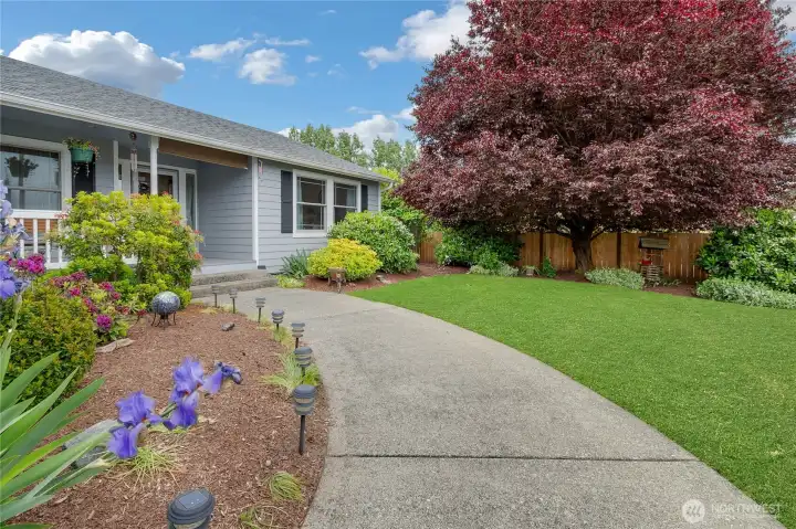 Front is fully fenced and is welcoming with covered porch and beautifully landscaped.