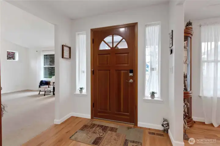 Entry with hardwood floor and living room off to the side.