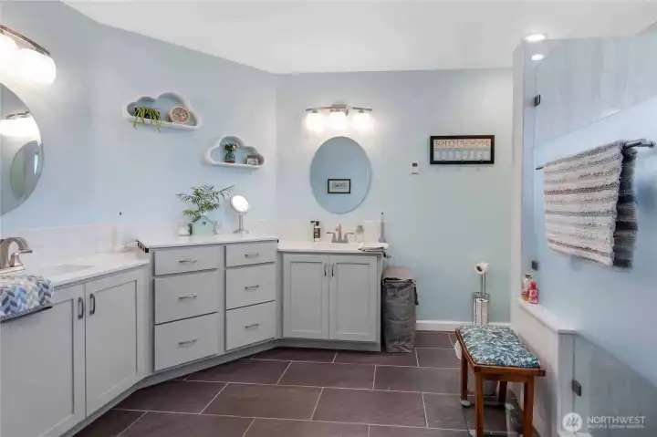 Primary bath is spacious and updated with two sinks, heated tile floors and great storage space.